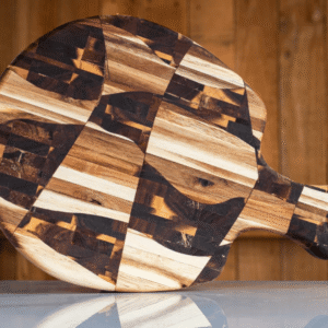 Blackwood padel chopping board displayed on a marble counter top